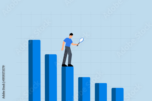 Business decline, Businessman examines decreasing bar graph and chart