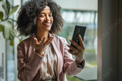 African american businesswoman communicating during a video call on phone
