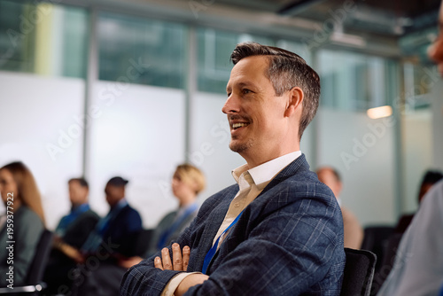 Schilderij op canvas Happy businessman paying attention on seminar at convention center