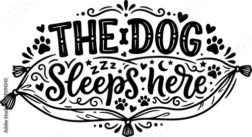 Black and white hand lettering the dog sleeps here with paw prints and decorative pillow