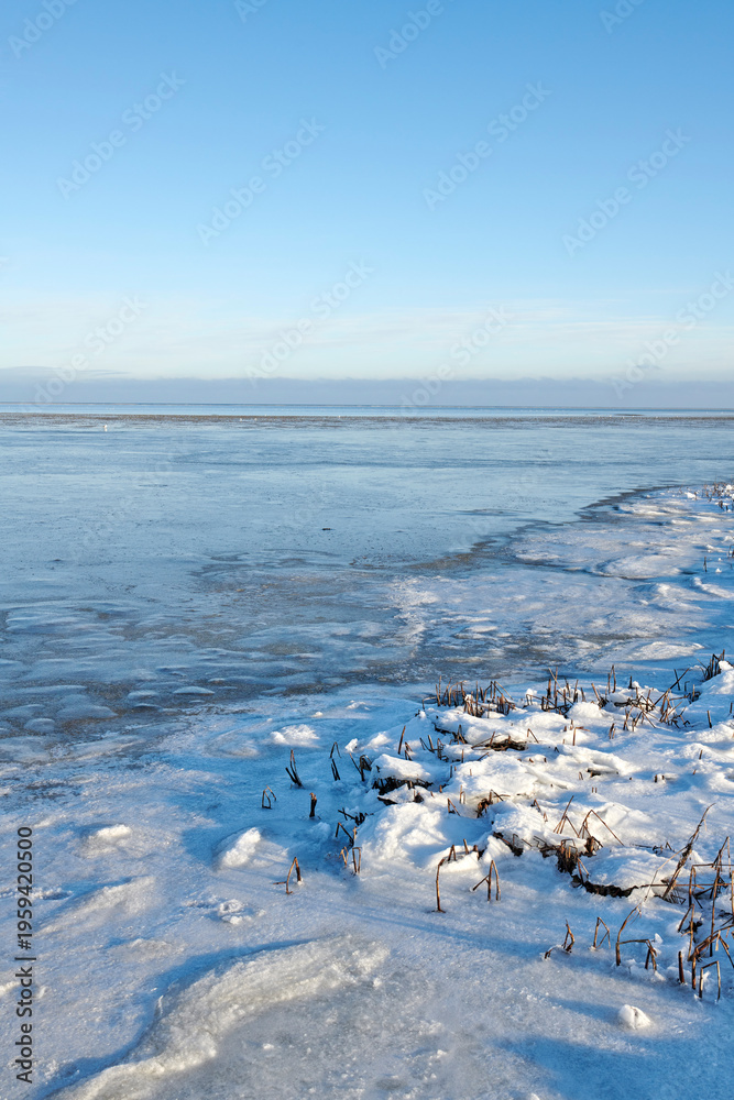 Obraz premium Landscape, blue sky and lake with snow in nature for climate change, winter season and morning frost. Space, meadow and river with ice formation, frozen field and icy conditions from global warning