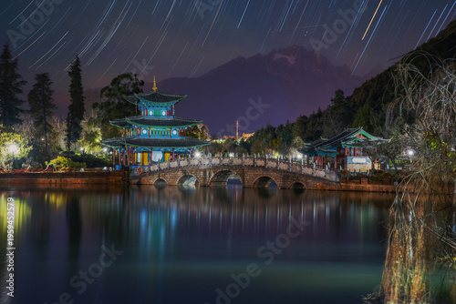 The beautiful scenery of ancient buildings in Yulong Snow Mountain and Heilongtan Park, Lijiang City, Yunnan Province, China were captured on January 12, 2026