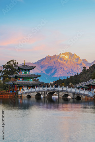 The beautiful scenery of ancient buildings in Yulong Snow Mountain and Heilongtan Park, Lijiang City, Yunnan Province, China were captured on January 12, 2026