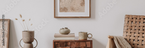 Elegant comosition of masculine room decor with small wooden cupboard, two mockup paintings and vintage accessories. Home staging. Template. Copy space.