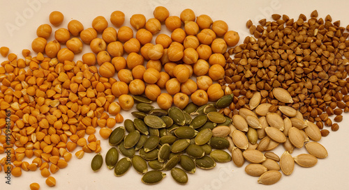 raw chickpea, buckwheat, maash and pumpkin seeds isolated on white