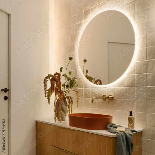 Elegant Bathroom with Round Illuminated Mirror and Vanity