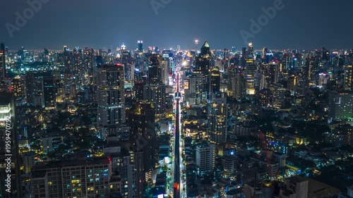Wallpaper Mural Bangkok downtown skyline illuminating cityscape with bustling highway traffic, urban skytrain, soaring skyscraper buildings at night from aerial Torontodigital.ca