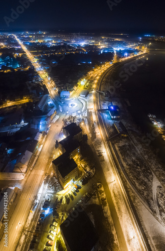 Aerial view of streets bathed in golden light, cutting through the inky blue darkness of night, illuminating the heart of the city, Sremska Mitrovica, Vojvodina, Serbia.