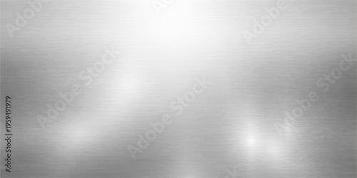 A brushed metal texture background features a polished stainless steel plate with a shiny silver metallic surface and light grey reflections on an aluminum sheet material