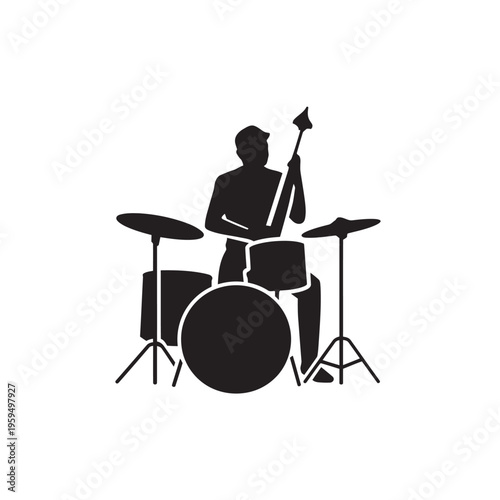 Musician playing the drum set, with bass guitar, performing on stage