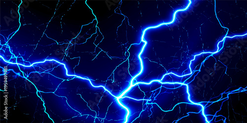 A powerful blue electric bolt strikes through the dark night sky during a dangerous nature thunderstorm as a bright flash of energy and light illuminate the black clouds