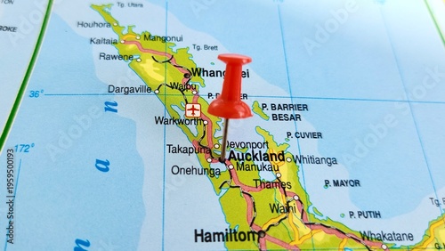 View of Auckland, is a large metropolitan city in the North Island of New Zealand, on a geographical map of Australia and New Zealand, marked with red push pin