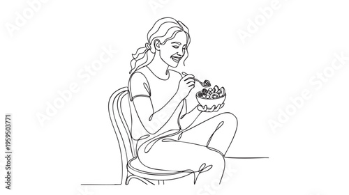 A young woman with her hair in a ponytail sits on a chair, smiling as she eats a colorful fruit salad from a bowl with a spoon.