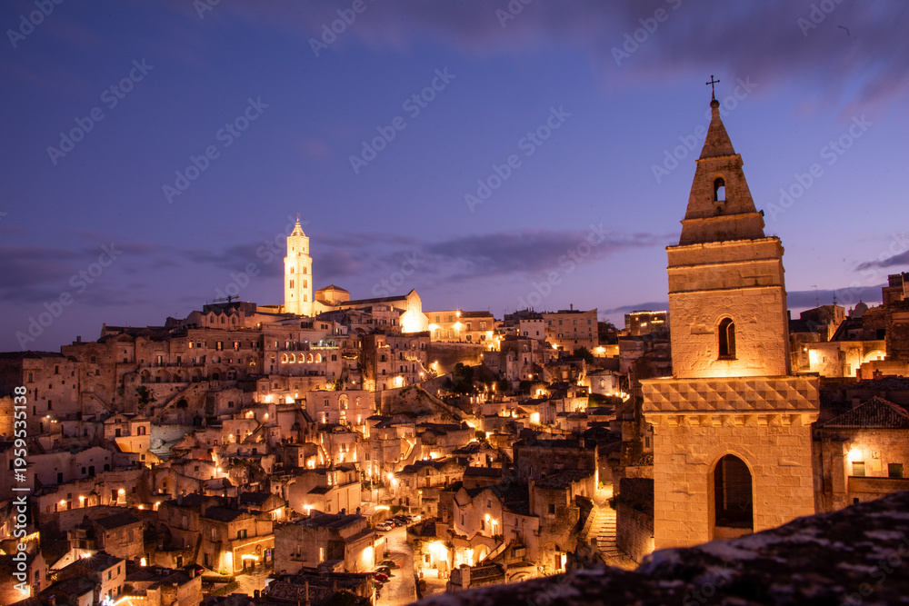 Fototapeta premium Matera in the blue hour, when the Sassi glow softly beneath a deepening southern sky.