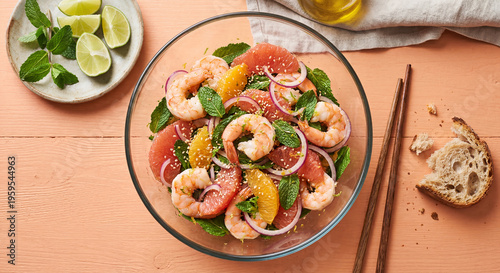 Shrimp citrus salad with grapefruit and orange segments and mint in a glass bowl