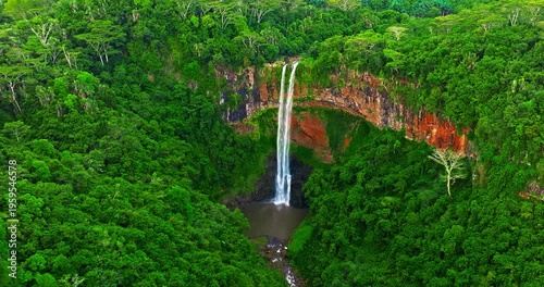Aerial view of Chamarel Waterfall, plunging from verdant cliff into shadowy, the highest waterfall on the island, Mauritius island