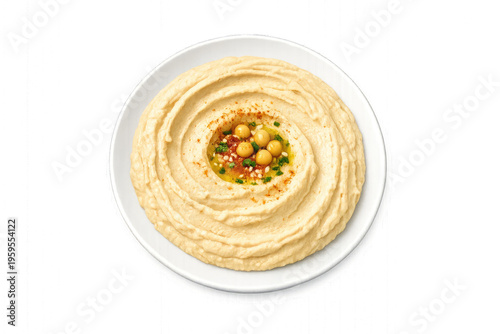 A bowl of hummus with chickpeas and spices is presented on a white plate.