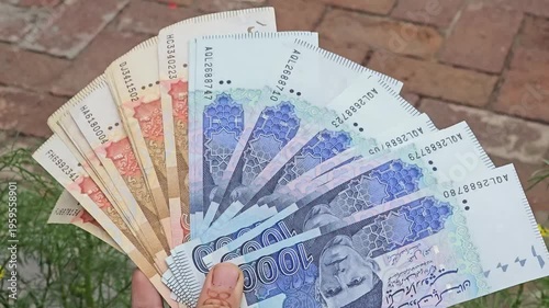 Pakistani Five Thousands and one thousands bank currency notes showcasing a variety of denominations fanned out in an organized manner for display