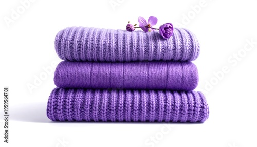Stack of Folded Purple Towels with Delicate Flower Accent.