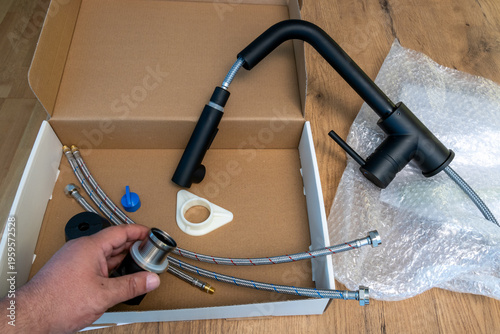 black kitchen faucet installation kit with hoses and components