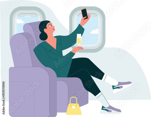 woman taking selfie and drinking champagne in business class airplane cabin