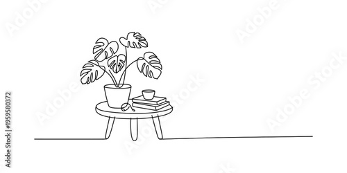 Continuous line drawing of a monstera deliciosa plant in a pot on a small round wooden table