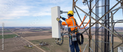 Telecommunication technician installing new 5g antenna on cell tower