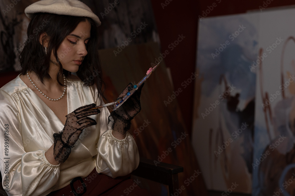 Fototapeta premium Artist creative young woman mixing colors on a palette, wearing beret and elegant gloves in artist studio