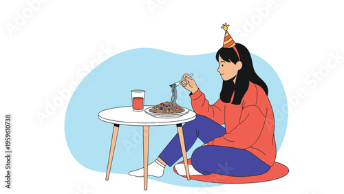 Young girl wearing a festive party hat sitting on the floor and eating a plate of spaghetti pasta from a small table.