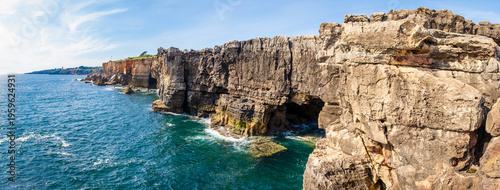 Boca do Inferno rock formations in Cascais, Portugal. Steep cliffs at Mouth of Hell limestone rock formations and sea caves in rugged shoreline of Atlantic ocean