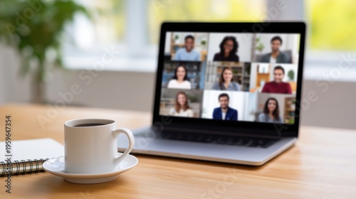 Laptop showing group video call on home office desk beside coffee cup.