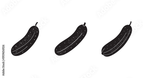 Three black pickles or cucumbers in a row on white background  pickled vegetables