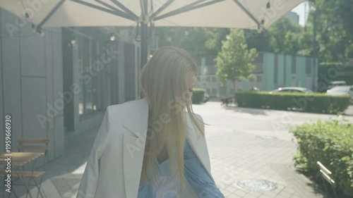 Elegant Woman Arriving And Sitting At Outdoor Cafe Terrace On Sunny Day