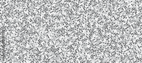 A densely patterned grayscale image displaying a chaotic arrangement of small scattered dots and grainy texture