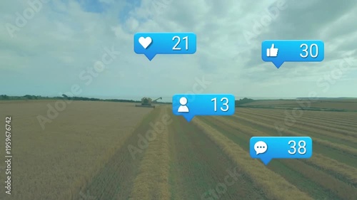 yellow combine harvester cutting wheat, while blue notification icons floating overhead