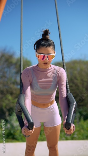 Summer outdoor training with rings and energetic fitness vibe