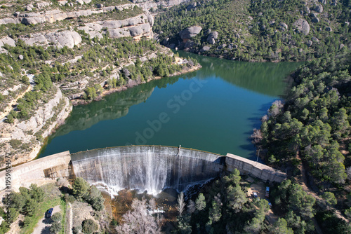 Aerial view of Margalef reservoir and dam on sunny winter day. Tarragona Province, Spain.