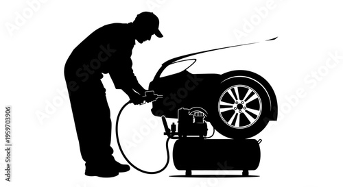 Mechanic inflating car tire with air compressor in garage