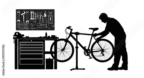 Man repairing bicycle on stand next to toolbox and monitor with instructions
