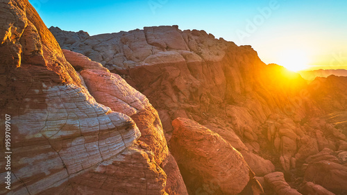 Tableau sur toile Red Rock Canyon Sunrise Aerial Sunburst Over Striated Red Sandstone Cliffs