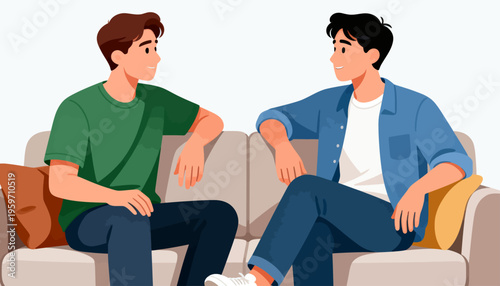 Two men sit on a couch, engaged in conversation. One wears a green shirt, the other, a blue jacket. They face each other with relaxed, attentive expressions. Their posture suggests a friendly