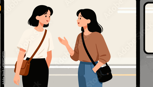 Two women chat warmly on a train platform. One gestures animatedly, smiling at her friend. The other listens, leaning slightly forward. Casual clothes and crossbody bags complete their look