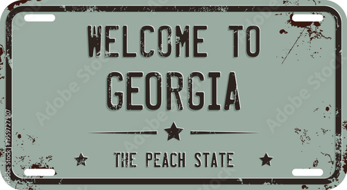 Welcome To Georgia message on rusty license plate