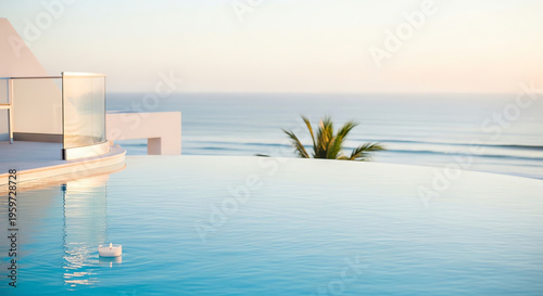 Infinity pool with ocean view at sunset surrounded by greenery  