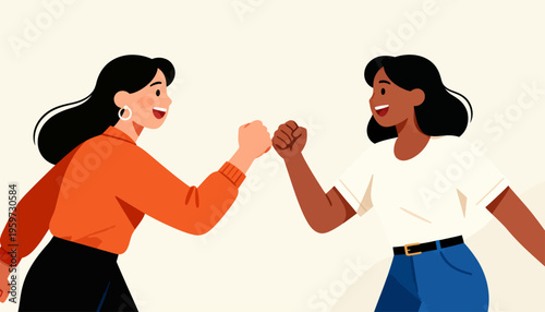 Two women smile as they fist bump in friendly agreement. Their joyful expressions show mutual respect and encouragement. The image suits themes of teamwork, friendship, or celebration