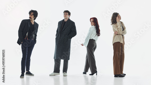 Photography Group of young adults standing in separate poses in clean studio environment