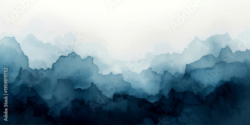 An aerial morning view of misty alpine peaks and forest hills under a soft blue sunrise sky creates a serene mountain landscape of light and fog