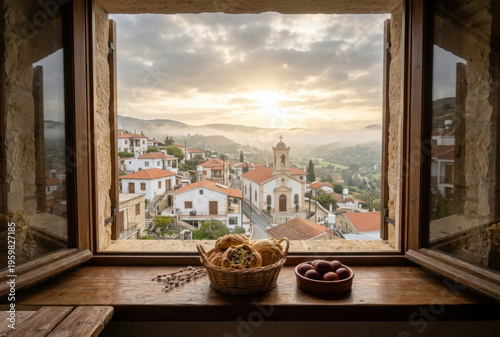 Looking out an open window to a traditional village and church at sunrise, with a basket of bread flaounes and red eggs on the windowsill, representing easter traditions. AI Generated