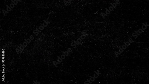 Dark grunge background animation featuring realistic chalk scratches, fine white veins, and subtle dust particles on black slate surface. Atmospheric texture for vintage title sequences, cinematic ove