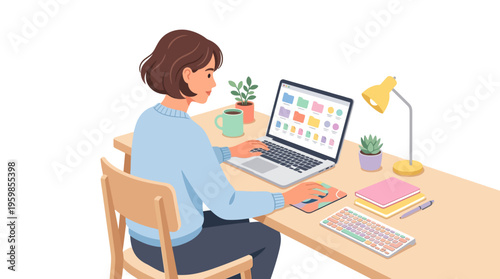 Young woman working diligently on her laptop at a desk.